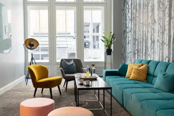 A living room with sofa, armchairs and coffee table.
