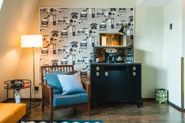 Living room in the suite Armchair and cupboard with coffee and tea station