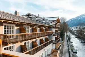 A building with balconies and a street in the foreground.