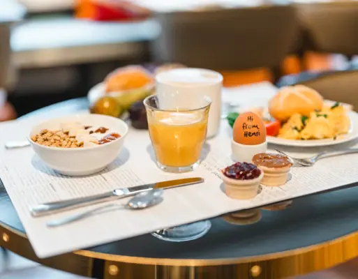 Breakfast at HENRI Hamburg on a table with crockery and dishes.
