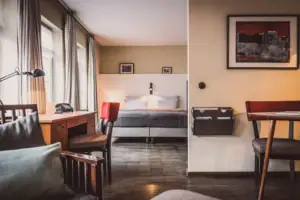 A room with a bed and a desk.