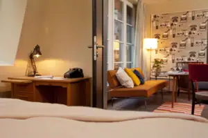 A room with a sofa and a desk.