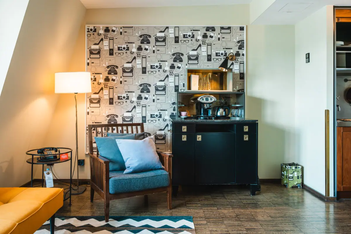 Armchair and cupboard with coffee and tea station