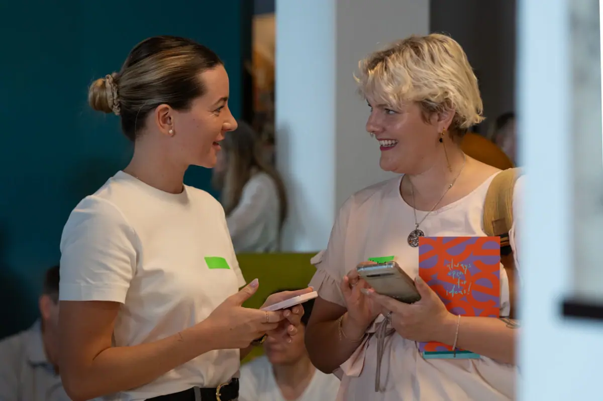 A woman talks to another woman.