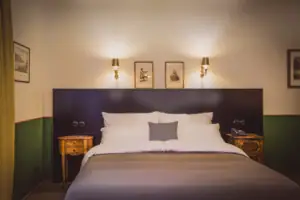 Bed with headboard and two lamps above