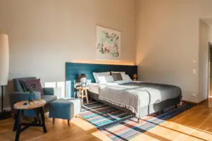 Bedroom with a bed and a chair.