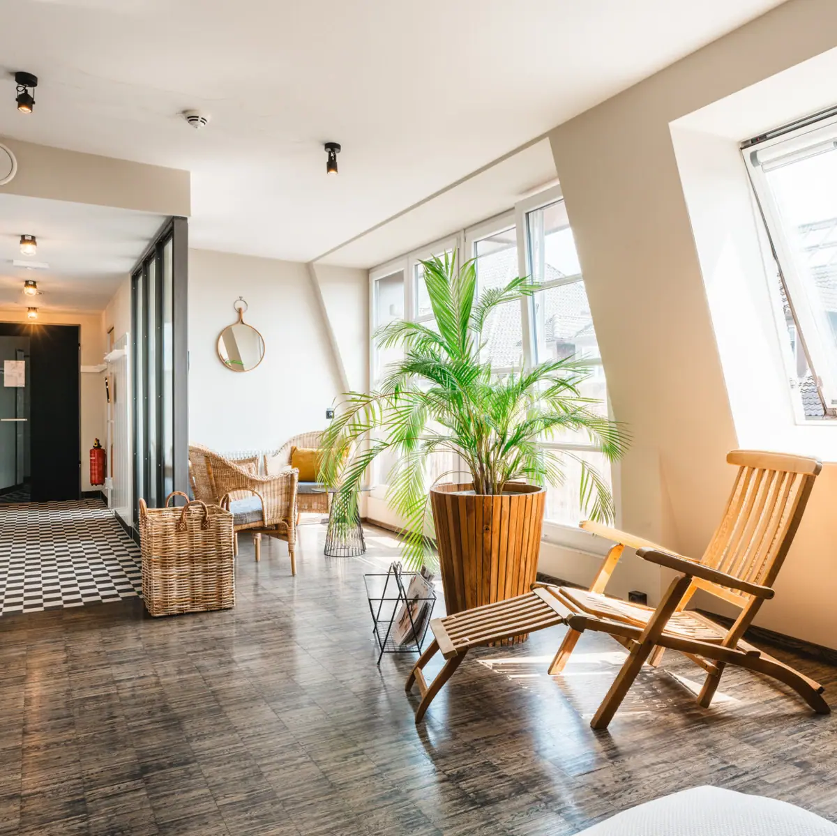 A room with a deckchair and a plant.