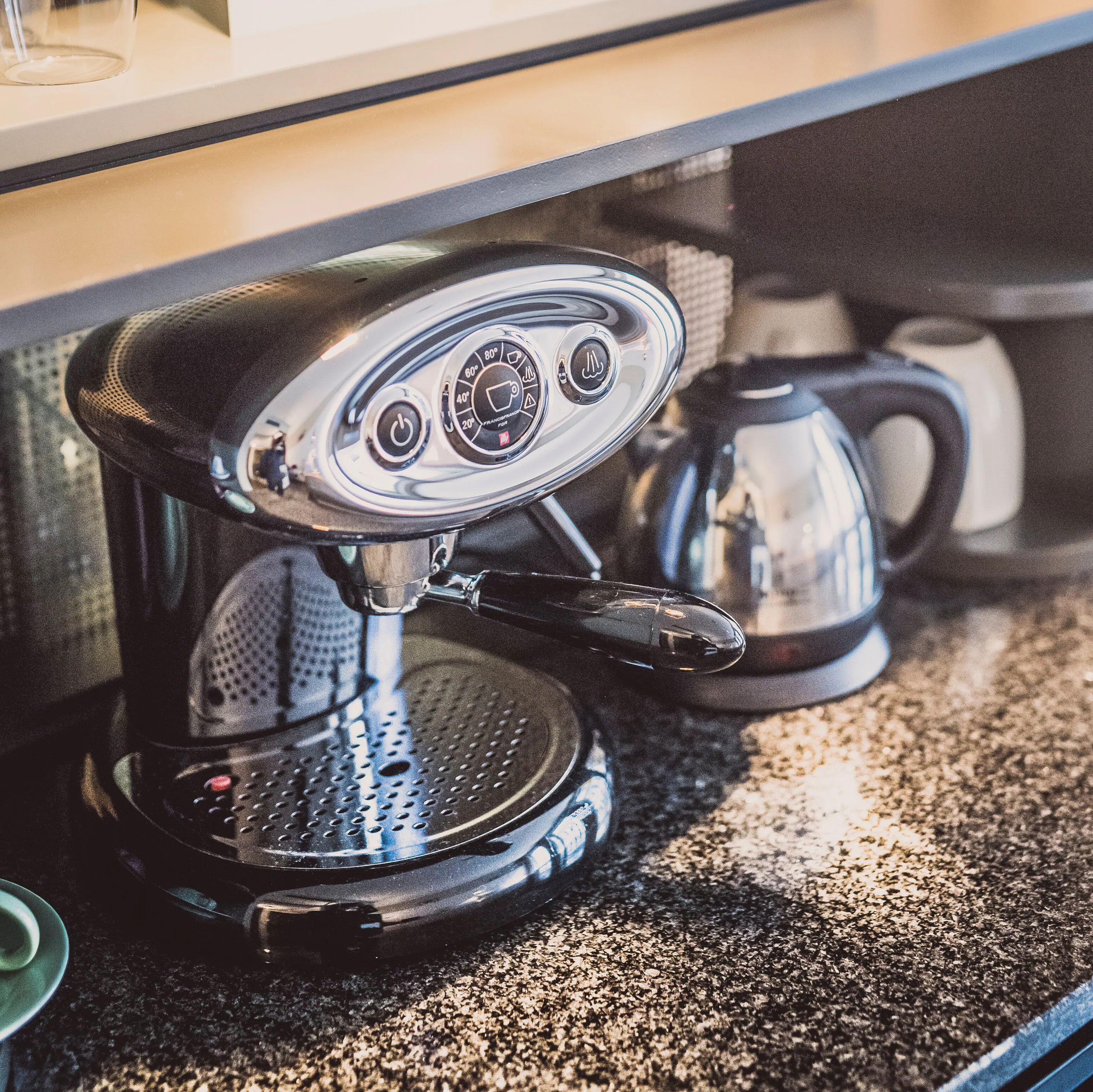 Coffee machine and kettle on a cupboard